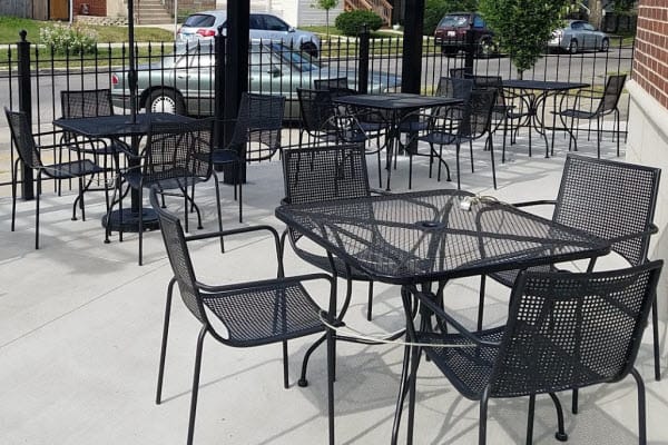 Black metal mesh patio chairs and tables